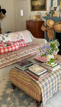 a living room filled with lots of furniture and flowers on top of a coffee table