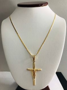 "18K GOLD FILLED CROSS NECKLACE . FOR GOOD LUCK,PROTECTION,HEALTH AND ANY KIND OF DIFFICULTY .18\" LONG CHAIN. PENDANT SIZE: 55 X 28 mm 18K GOLD FILLED CADENA DE CRUZ . PARA PROTECCION,BUENA SUERTE,SALUD Y PARA CUALQUIER CASO DIFICIL.18\" LARGO CADENA. TAMANO DEL DIJE: 55 X 28 mm" Gold Plated Crucifix Jewelry With Adjustable Chain, Gold Crucifix With Figaro Chain Jewelry, Gold Plated Crucifix Necklace Tarnish Resistant, Gold Plated Tarnish Resistant Crucifix Necklace, Gold-plated Tarnish-resistant Crucifix Necklace, Gold Plated Crucifix Necklace, Gold Crucifix Necklace In 14k Gold, Gold Crucifix Necklace With Box Chain, Gold Crucifix Jewelry With Box Chain