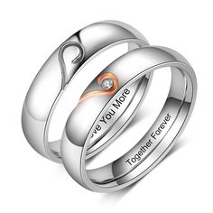 two wedding rings with the words love you more engraved on each one and an orange diamond in