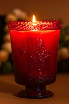 a red candle is lit on a table