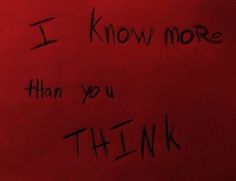 a red wall with writing on it that says i know more than you think