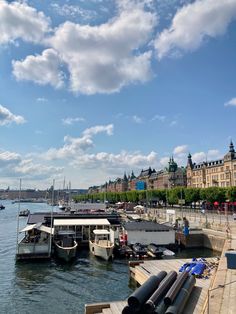 boats are docked in the water near some buildings