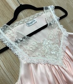 "Here we have luxurious authentic Christian Dior pink nightgown. This beautiful vintage gown features lace detail, soft satin material and side slits. Size: Petite - This could also fit a size Small/Medium as well (model shown is 6 feet tall and wears a 6/8 dress and 34DD bust and this nighty fit beautifully) 31.5-38\" in length 9.5\" arm openings 18\" across from underarm to underarm 24.5\" across the waist 29\" across the hips Lovely vintage condition - no flaws to mention! As always, shipping Cheap Pink Sleep Nightgown, Pink Satin Slip Dress With Lace Trim, Pink Lace Trim Evening Slip Dress, Sleeveless Satin Slip Dress With Lace Bodice, Pink Lace Trim Slip Dress For Evening, Satin Sleeveless Nightgown With Delicate Lace, Sleeveless Satin Nightgown With Delicate Lace, Sleeveless Satin Slip Dress With Contrast Lace, Feminine Delicate Lace Sleeveless Sleepwear