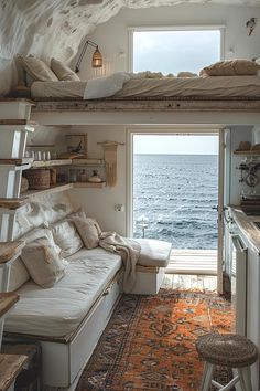 a living room filled with furniture next to the ocean