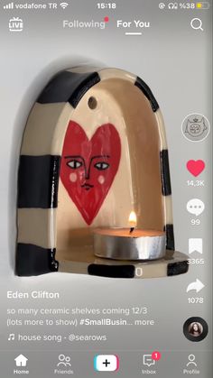 an image of a heart on a toaster that is being used as a candle holder