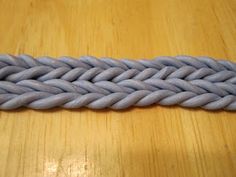 a close up of a rope on a wooden table