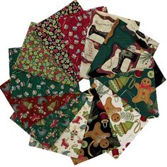 many different types of christmas fabric are arranged in a circle on a white tablecloth