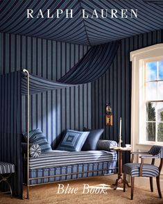 a blue room with striped walls and furniture