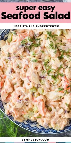 a bowl filled with seafood salad on top of a blue and white striped plate next to a