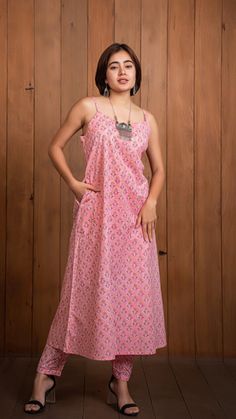 Prisha Sanganeri Hand Block Cotton Kurta - Peach, Sleeveless Long Kurti With Pockets, Bridesmaids dress, Indian Hand Block Printed Cloth Flaunt the exclusive handcrafted kurta in sanganeri block print. A modern and chic silhouette hand made only for you. Features a round neck and A linesilhouette to suit all body types. Sleeveless design to make you look stylish as well as comfortable. Straight pants made in pure cotton fabric. Made in 100% cotton. Kurta can be brought separately. Model height is 5.1" and is wearing a size S. Returns Policy: Eligible for returns within 7 days of delivery. Sleeveless Pink Maxi Dress For Wedding, Peach Sleeveless Dresses For Wedding, Sleeveless Peach Wedding Dress, Peach Sleeveless Wedding Dresses, Pink Cotton Maxi Dress With Spaghetti Straps, Peach Sleeveless Sundress For The Beach, Sleeveless Peach Sundress For Beach, Peach Sleeveless Beach Sundress, Pink Bohemian Halter Neck Sleeveless Dress