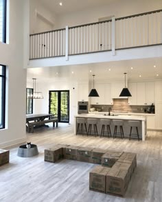 a large open floor plan with white walls and wooden floors