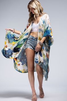 Wrap yourself in elegance with our Watercolor Open Front Kimono! Featuring a delicate and light watercolor effect, this kimono is perfect for everyday wear. One size fits most, making it versatile to layer over jeans, a maxi dress, or even a swimsuit. Crafted from lightweight, flowing fabric, it's the perfect addition to your wardrobe. 100% Viscose Length: 38" Width: 40" One Size Fits Most Watercolor Print Open Front Cover Up Chic Spring Unlined Cover-up, Chic V-neck Summer Kimono, Chic Unlined Spring Cover-up, Blue Breezy Summer Cover-up, Blue Breezy Flowy Cover-up, Blue Flowy Breezy Cover-up, Oversized V-neck Spring Cover-up, Summer Wrap Cover-up Free Size, Spring Flowy Wrap Cover-up