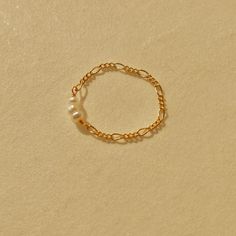 This dainty pearl ring is handcrafted with 14k gold filled Figaro chain and mini freshwater pearls. Its simplicity made it a perfect stackable ring. The gold filled material is tarnish-free and never turns your fingers green!  Shop the matching earring, necklace and bracelet here: https://www.etsy.com/ca/listing/1041079879/mini-freshwater-pearl-and-figaro-chain https://www.etsy.com/ca/listing/938893891/mini-freshwater-pearl-choker-14k-gold https://www.etsy.com/ca/listing/1019412027/mini-freshwat Minimalist Pearl Stackable Jewelry, Minimalist Stackable Pearl Jewelry, Everyday Gold Ring With Pearl Charm, Dainty Stackable Pearl Jewelry, Everyday Gold Pearl Ring, Dainty Adjustable Pearl Stackable Rings, Delicate Gold Stackable Pearl Ring, Dainty Gold Stackable Pearl Rings, Dainty Adjustable Hypoallergenic Pearl Ring