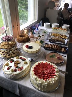 a table filled with cakes and desserts on top of it