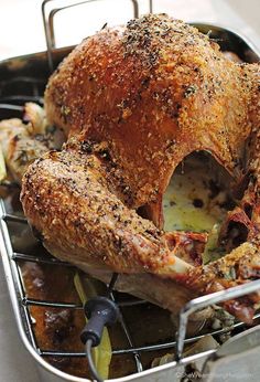 a roasting pan with a whole chicken in it