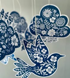 blue paper birds hanging from strings with flowers