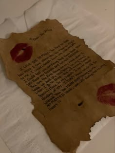 a piece of paper with writing on it that has red lips drawn on the side