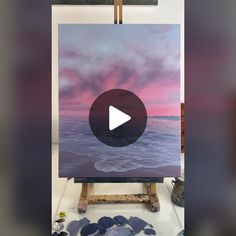 an easel with a painting on it in the process of being painted by someone