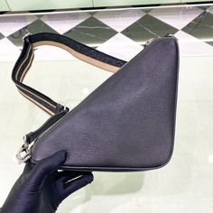 SHOP MORE LUXURY PRODUCTS HERE Description Prada Saffiano Triangle Bag Black For Women, Women’s Bags 11in/28cm 2VH155_2FAD_F0002_V_OOO This triangular bag in Prada’s emblematic geometric shape is made of Saffiano , an iconic material of the brand defined by its crosshatch texture and waxed finish. The triangle logo is also found in the embossed macro detail decorating the front. The Re-Nylon lining, an innovative fabric made of regenerated nylon yarn, completes the design. Size: 28 x Prada Re Edition 2005, Louis Vuitton Shirt, Triangle Bag, Chanel Shirt, Fabric Handbags, Prada Saffiano, The Triangle, Luxury Products, Triangle Logo