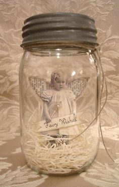 a glass jar filled with shredded paper and an angel on the front, saying fairy wishes