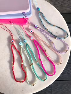 Beaded phone lanyard with evil eye bead 🧿 to be attached to your phone case   These can be looped through your phone case or looped through one of our heart shaped phone charm holders below:   https://www.etsy.com/uk/listing/1410899591/phone-holderphone-gripphone-charm-holder?click_key=5cd45d79fa174ea244000f274678d1d0e01f7ff9%3A1410899591&click_sum=7b0ed69c&ref=shop_home_active_6&pro=1 Gift packaged in our organza gift bag with business card Holder Phone, Charms For Phone Cases, Beaded Phone Case, Charm Phone Cases, Cute Phone Strap, Charm Phone, Phone Case Bracelet, Phone Case Holder Beads, Phone Holder Beads