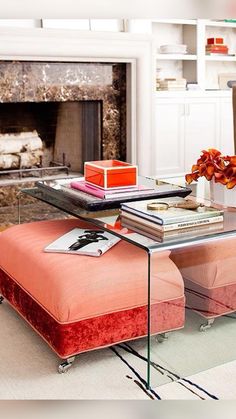 a living room filled with furniture and a fire place in the centerpiece on top of a coffee table