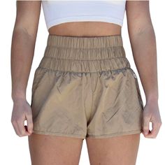 these free people running shorts are light and breezy. they feature a surprisingly comfortable high-rise smocked waistband that can easily be folded down and a side split hem for added style. also available in army green, varsity gold, optic white, deep sea, moonlight mauve, artic mist, black and trance print. details 100% nylon machine wash cold size + fit model is 5'7 wearing a size small Free People Running, People Running, Free People Movement, Side Split, Deep Sea, Split Hem, Running Shorts, Army Green, Mist