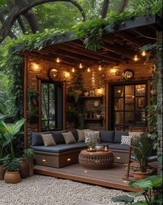 an outdoor living area with couches, tables and potted plants on the ground