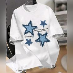 Ladies White Graphic T-Shirt With Blue Stars Size Medium By Shein Polyester Cotton And Elastane Fabric Brand New Trendy Blue Top With Star Print, Trendy Blue Star Print Top, Blue Cotton Star Print Tops, Blue Short Sleeve Tops With Star Print, Blue Short Sleeve Top With Star Print, Blue Graphic Tee With Star Print, Blue Star Print Graphic Tee, White Star Print Short Sleeve Top, Blue Star Print Top With Relaxed Fit