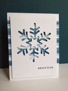 a white card with blue snowflakes on it and the words peace & joy