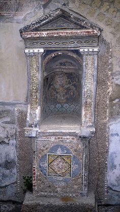 an old fountain in the middle of a stone wall