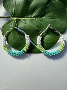 These green beaded hoop earrings are made with premium Czech glass seed beads. Earring Hoops: 35mm sliver plated (Nickel Free) for the sensitive skin. They're modern and pretty. They'll definitely add a fresh spring flair to you. This item is only 1 available. After purchased, I don't accept exchange. I do accept returns. About return this item, please refer to the store policy. All items of my store will be packed in a nice gift box(Ready to Gift). Please take a look at some of the other items in my shop: https://www.etsy.com/shop/HappyGemsandBeads If you have any question, please feel free to message me on Etsy. I'll be glad to answer your questions as soon as possible. Thank you for your support! Green Hoop Earrings With Ear Wire, Handmade Green Hoop Earrings For Beach, Green Beaded Dangle Hoop Earrings, Green Beaded Hoop Earrings For Summer, Green Small Hoop Earrings For Summer, Small Green Hoop Earrings For Summer, Summer Beaded Green Hoop Earrings, Green Beaded Earrings For Summer, Summer Green Beaded Hoop Earrings