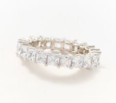 a white gold ring with princess cut diamonds