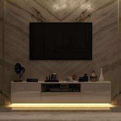 a tv is mounted on the wall in a room with marble walls and flooring