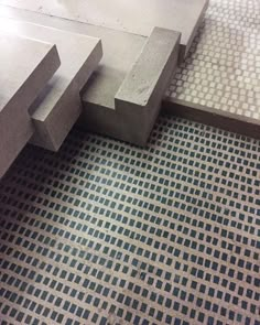 a close up of some concrete steps on a tiled floor