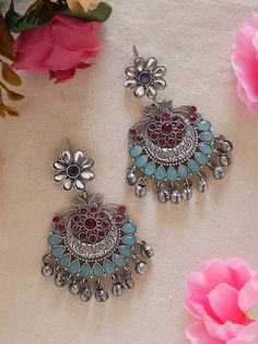 Discover elegance in our Pink Blue Ethnic Silver Earrings with Ghungroos. Meticulously handcrafted, these earrings seamlessly fuse traditional charm with contemporary style. The vibrant pink and blue and silver combination, coupled with intricate ghungroos, adds a unique flair to any outfit. Lightweight and versatile, they're perfect for both casual and formal occasions, allowing you to effortlessly embrace cultural sophistication. Elevate your style with these statement earrings that blend tradition and modernity with finesse. Available in two more stunning colour options.  In case of any queries, please feel free to contact us. Happy shopping! Festive Bohemian Dual-tone Earrings, Traditional Multicolor Oxidized Earrings, Festive Bohemian Dual-tone Danglers, Traditional Oxidized Drop Earrings Jhumkas, Traditional Oxidized Jhumkas Drop Earrings, Bohemian Dual-tone Danglers For Gift, Traditional Oxidized Finish Festive Danglers, Festive Metal Chandbalis With Oxidized Finish, Traditional Oxidized Danglers For Festive Occasions