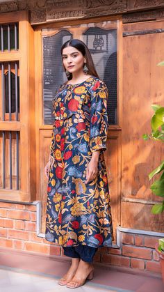 A line kalamkari kurta with plain blue harem pants. Made in printed raw silk. Features frill detailing on the neck. Harem elastic waist pants. Colour : Blue. Model height is 5.3” and is wearing a size S. Wash Care : Dry Clean Only. Silk Anarkali Kurta With Kalamkari Print, Blue Floral Chanderi Kurta, Festive Batik Print Straight Kurta, Navratri Harem Kurta, Multicolor Cotton Silk Kurta With Kalamkari Print, Blue Chanderi Kurta With Kalamkari Print, Blue Anarkali Kurta With Kalamkari Print, Unstitched Batik Print Kurta For Eid, Blue Kurta With Kalamkari Print