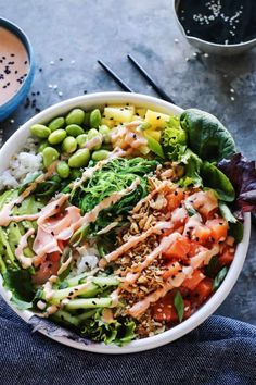 a white bowl filled with vegetables and rice