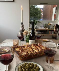 a table topped with plates of food and glasses of wine