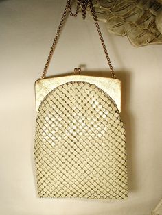 Offering a gorgeous vintage 1940s - 1950s era warm ivory/light champagne mesh Art Deco flapper purse made by Whiting & Davis in near PRISTINE vintage condition and perfect for the Bride! If you've ever seen one of these purses in person you know just how well made they are. The mesh has a wonderful fluidity and movement so it shimmers as it catches the light. I love the SO 1920's Art Deco flapper design of this one. The frame is a beautiful textured/brushed gold on the front and back and shiny gold along the edges. Photos don't begin to do this bag justice or capture the sparkle of the mesh or frame adequately.  The bag measures 7.5 inches (19.1 cm) high, not counting the clasp, and is 5 1/2 inches (13.9 cm) wide along the bottom so it will easily fit your essentials including your phone. Cream Rectangular Evening Bag, Vintage Beige Party Bag, Vintage Cream Bags For Vintage Events, Vintage Rectangular Evening Bag, Elegant White Evening Bag For Vintage Events, Vintage Rectangular Wedding Bags, White Vintage Party Bag, Vintage White Party Bags, Vintage Cream Bags