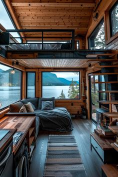 the interior of a tiny cabin with lots of windows