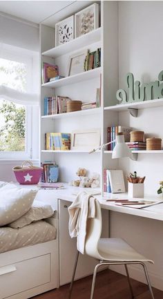 a bedroom with white walls and shelves filled with books