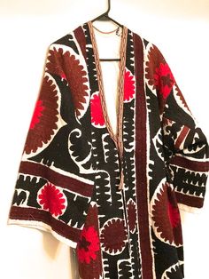 "Vintage fully embroidered Uzbek kimono coat Size M/L This is a gorgeous antique handmade embroidered suzani robe dress. This magnificent piece of art is part of the interesting culture and traditions of the people of Tajikistan and Uzbekistan. Suzani embroideries are used as an element of interior decoration and also as a ritual symbol connected with the ancient beliefs of this culture. The Suzani designs are flowers, nest, images of birds, and other ancient symbols. Measurements: Shoulder to s Traditional Cape Kaftan For Festive Occasions, Traditional Cape Style Festive Kaftan, Traditional Cape-style Festive Kaftan, Traditional Cape-shaped Festive Kaftan, Traditional Fall Festival Kimono, Traditional Festive Fall Kimono, Traditional Fall Festive Kimono, Traditional Multicolor Embroidered Kimono For Fall, Traditional Brown Kaftan With Kimono Sleeves