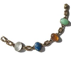 "Vintage gold filled scarab bracelet in the retro style was made by Engel Brothers during the past mid century. Hand carved semi precious stones are  aventurine, citrine quartz, sodalite and clear quartz. The fold over clasp blends nearly invisibly with the gold filled links, creating a seamless look we love. Ancient Hieroglyphs show the interpreted meaning of the scarab is \"to be transformed\".  Perhaps it may be your very own totem of new life and new beginnings? Bracelet length is 7 inches. Ancient Hieroglyphs, Scarab Bracelet, Bracelets With Meaning, The Fold, Semi Precious Stones, Chain Link Bracelet, 10k Gold, Clear Quartz, New Beginnings