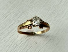 a close up of a gold ring with a diamond