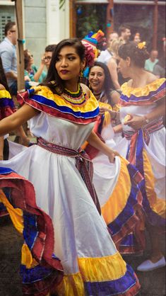 a group of people that are standing in the street with some kind of dress on