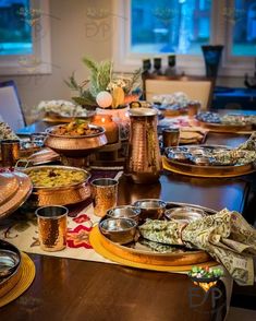 a table with many plates and bowls on it