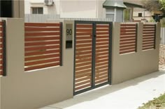 a fence with wooden slats on it and a mailbox at the top that reads 30