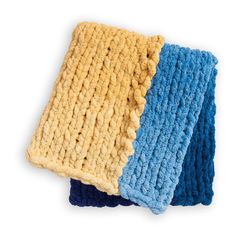 two crocheted dishcloths sitting next to each other