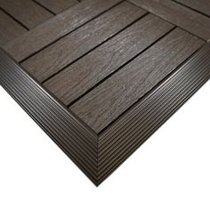 a close up view of the decking material on an outdoor patio area with dark woodgrain